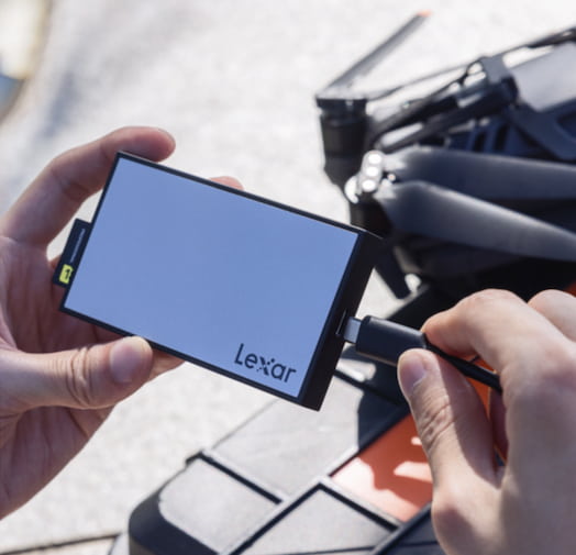 A professional videographer using a Lexar Card Reader.